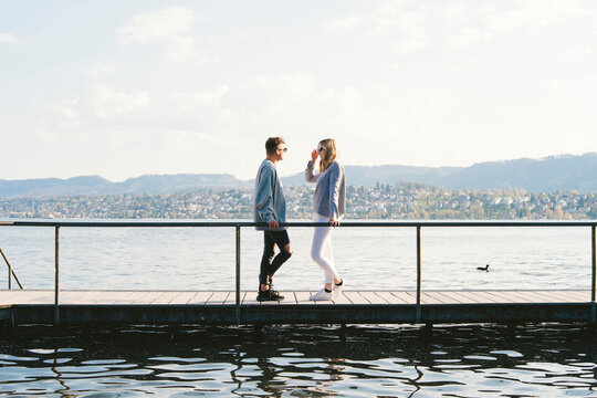Young couple standing on jetty at Lake Zurich, Zurich, Switzerland