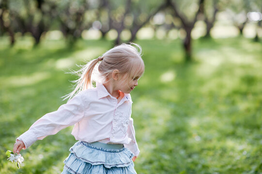 Blond little girl on a meadow