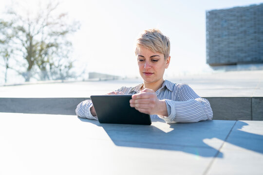 Portrait of young woman using digital tablet