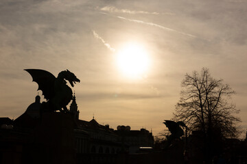 Slovenia, Ljubljana, silhouettes of  dragon sculptures of Zmajski most at sunset