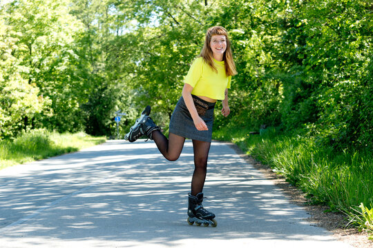Portrait of young woman with inline skates