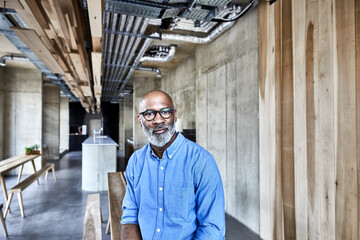 Portrait of confident mature businessman in modern office
