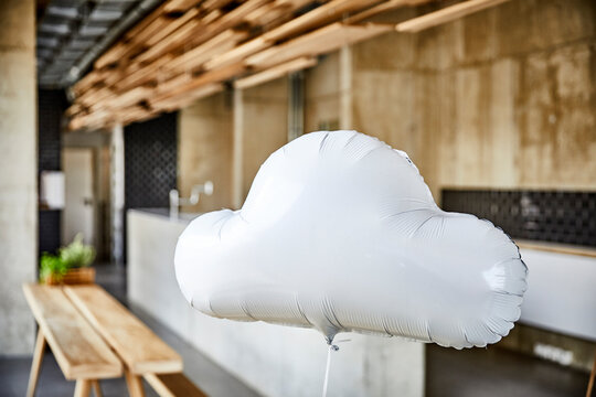 Cloud balloon floating in creative office
