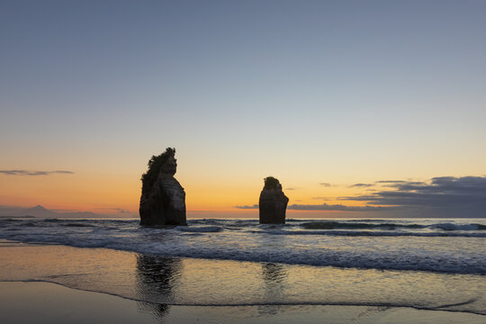 New Zealand, New Plymouth District, Tongaporutu, Three Sisters rock formation at dusk