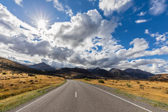 New Zealand, Bealey, Clouds over empty State Highway 73 with mountains in background