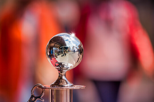 Chromed knob of a hand rail, selfie of the photographer