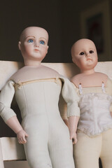Pair of Vintage dolls on vintage chair - doll parts