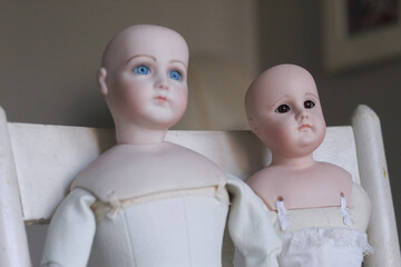 Pair of Vintage dolls on vintage chair - doll parts