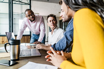 Confident business team having a meeting in loft office