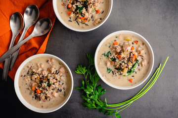 Bowls of Chicken and Wild Rice Soup: Overhead view of creamy chicken and wild rice soup with...