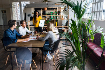 Businesswoman leading a presentation in loft office