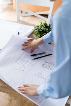 Close-up of woman in office working on plan on table