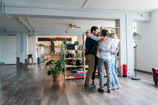Business team huddling in loft office