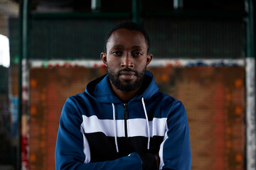 Portrait of young man with crossed arms