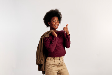 African American girl in brown sweater poses showing her hands - 462724428