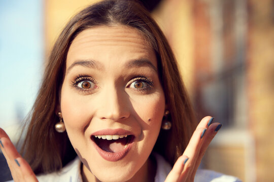 Close-up of businesswoman with surprised facial expression standing outdoors