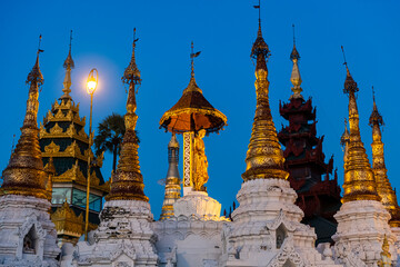 Myanmar, Yangon, Golden spires of Shwedagon pagoda at dusk