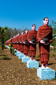 Myanmar, Mon state, outside of Mawlamyine, Row of Buddhist monks statues at Win Sein Taw Ya