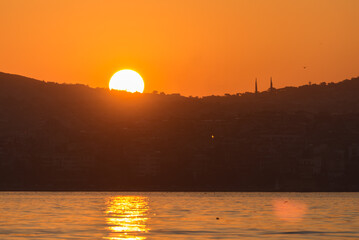 Epic Sunrise behind Mosque silhouette over Bosphorus, Istanbul, Turkey.