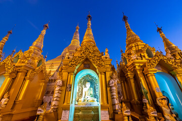 Myanmar, Yangon, Golden spires and Buddha statue atÔøΩShwedagon pagoda