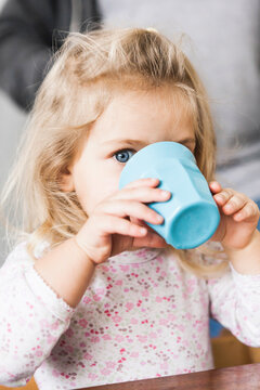 Girl drinking from plastic cu