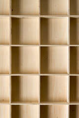 shallow wooden box with square compartments