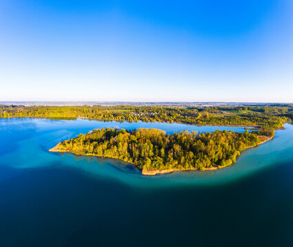 Germany, Bavaria, Inning am Ammersee, Drone view of clear sky over forested shore of Worth island