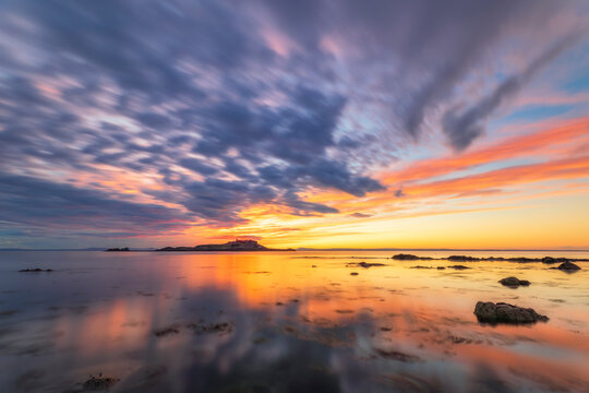 Tranquil view of Yellowcraigs Beach against cloudy sky, East Lothian, Scotland during sunset