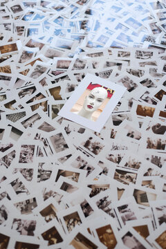 Picture of female mannequin lying on top of photographic slides strewn across floor