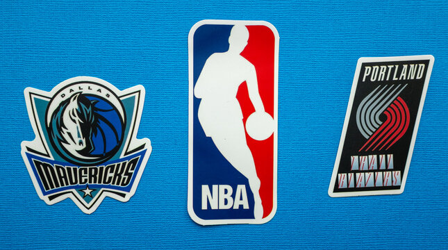 October 1, 2021, Springfield, USA, Emblems Of The Dallas Mavericks And Portland Trail Blazers Basketball Teams On A Blue Background.