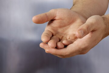 Businessman with cupped hands against the background. business, professionalism and technology concept