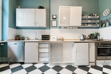 Tidy apartment kitchen withÔøΩcheckerboard floor