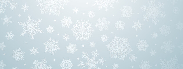 Christmas background of big and small complex snowflakes in light blue colors