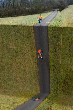 Young male athlete fallen from bicycle while riding on abyss