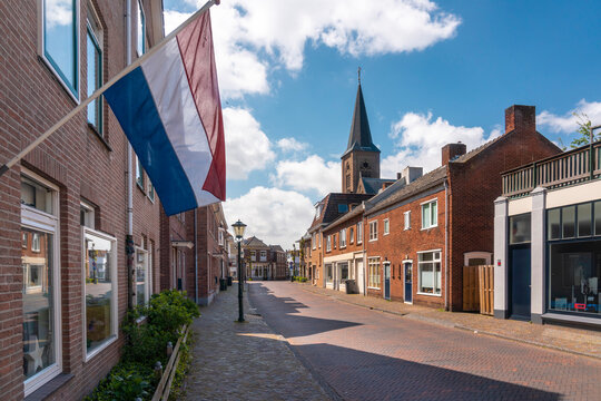 Netherlands, South Holland, Noordwijk, Dutch flag fluttering over empty town street