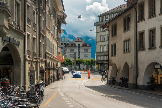 Cars moving on road amidst old buildings in Baelliz, Thun, Switzerland