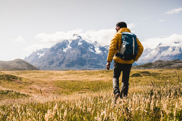 Man with backpack hiking at Torres Del Paine National Park in Patagonia, South America