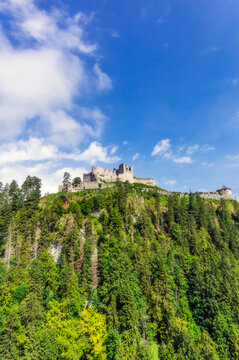 Austria, Tyrol, Reutte, Ruins of Ehrenberg Castle standing on top of forested hill in summer