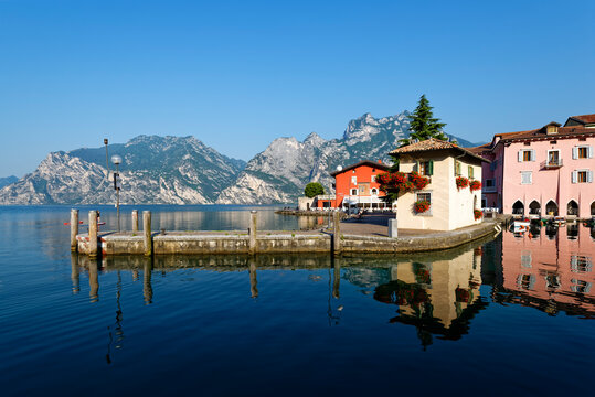 Italy, Trentino, Torbole, Lake Garda, Pier and houses on lakeshore