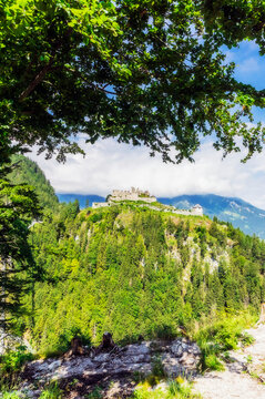 Austria, Tyrol, Reutte, Ruins of Ehrenberg Castle standing on top of forested hill in summer