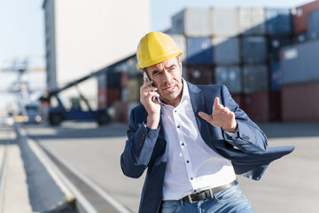 Portrait of businessman on the phone at industrial site