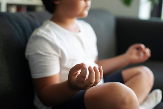 Boy sitting on couch meditating