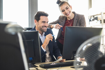 Business people using computer while working together at office