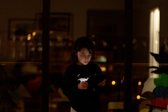 Boy using tablet at home in the night