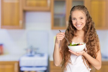 Portrait of attractive woman hold salad bowl and look at camera.