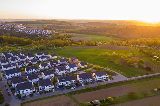 Germany, Baden-Wurttemberg, Waiblingen, Aerial view of modern suburb at sunset