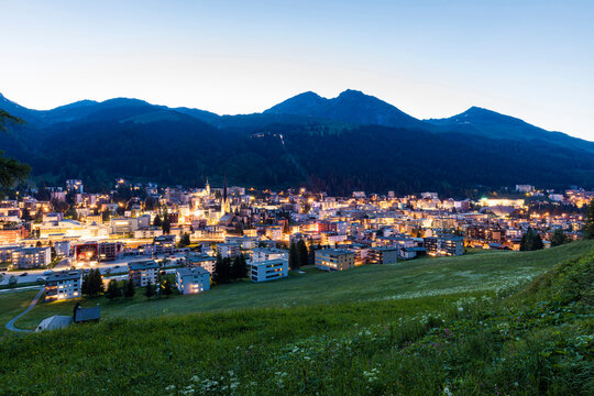 Switzerland, Canton of Grisons, Davos, Illuminated town in Rhaetian Alps at dusk