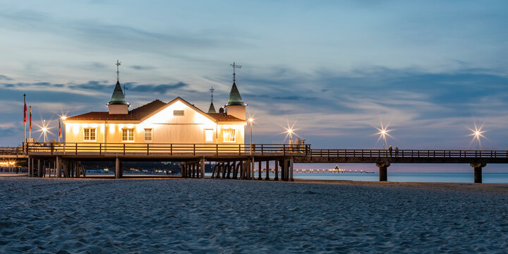 Germany, Mecklenburg-Western Pomerania, Heringsdorf, Illuminated Ahlbeck Pier at dusk