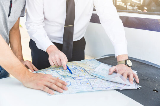 Pilots marking route on visual flight chart