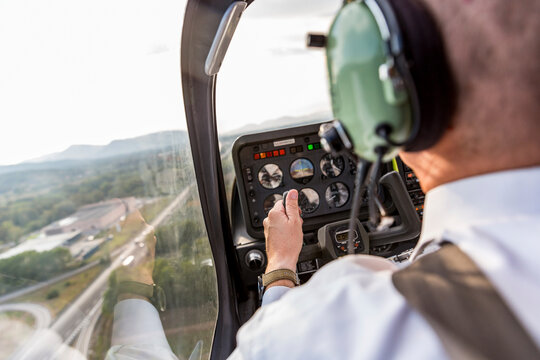 Pilot flying in sports plane, VFR chart on his lap